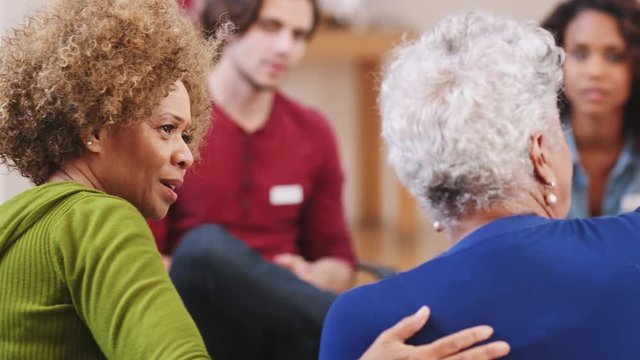 People Attending Self Help Therapy Group Meeting In Community Center