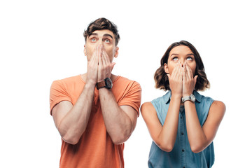 shocked man and woman looking up and covering faces with hands isolated on white