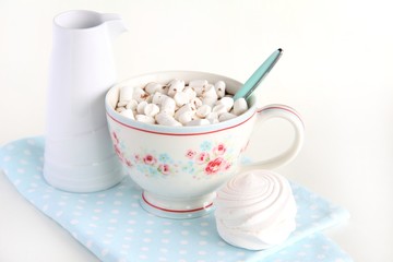 A Cup of cocoa and marshmallows on a white background.