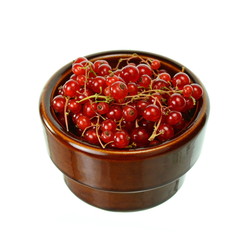 Red currants in a bowl isolated on white background