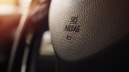 Safety airbag sign on car steering wheel with horn icon