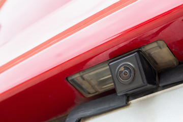 Red car rear view camera close up for parking assistance