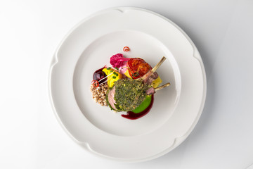 Kare calf (beef ribs) with potato gratin, horseradish mousse and buckwheat popcorn. Banquet festive dishes. Fine dining restaurant menu. White background.