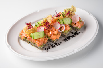 Bruschetta with salmon, avocado, capers, cucumber, radish, sweet pepper and cherry tomatoes. Banquet festive dishes. Fine dining restaurant menu. White background.
