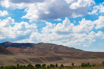 Fototapeta premium Steppe landscapes of Kazakhstan. Sky with clouds over the mountains