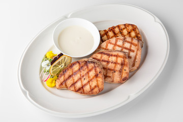 Grilled salmon fish fillet (red fish). Seafood. Banquet festive dishes. Fine dining restaurant menu. White background.