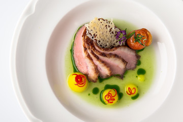 Sliced pork carving in sauce with mashed potatoes and grilled vegetables. Banquet festive dishes. Fine dining restaurant menu. White background. 