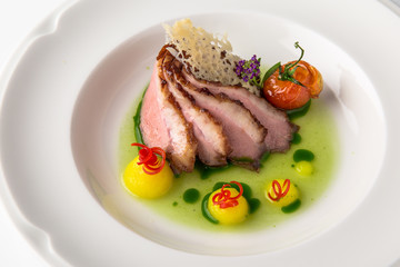 Sliced pork carving in sauce with mashed potatoes and grilled vegetables. Banquet festive dishes. Fine dining restaurant menu. White background. 