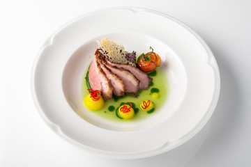 Sliced pork carving in sauce with mashed potatoes and grilled vegetables. Banquet festive dishes. Fine dining restaurant menu. White background. 
