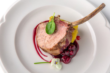Calf or pork ribs cooked in the oven with cherry sauce, vegetable puree. Beef or pork meat. Banquet festive dishes. Fine dining restaurant menu. White background. 