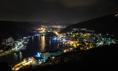 Fototapeta na wymiar Night landscape Balaklava, Crimea. Landscape of night city and sea Bay