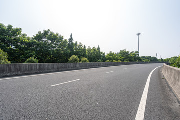 empty asphalt road with city skyline