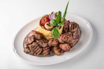 Skewers of pork, beef with vegetables and mushrooms. Grilled meat. Banquet festive dishes. Fine dining restaurant menu. White background. 