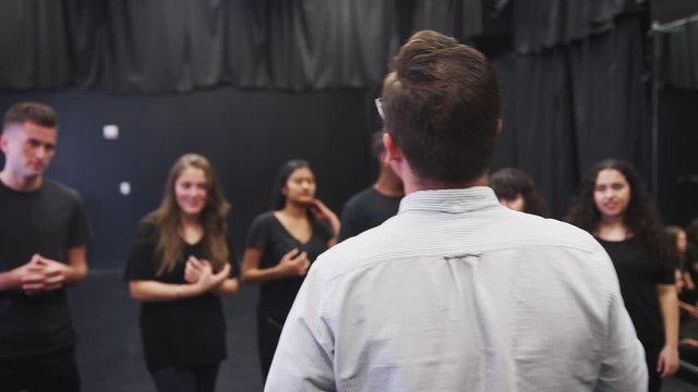 Teacher With Drama Students At Performing Arts School In Studio Improvisation Class