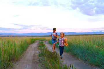 little boys running in field