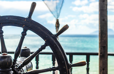 The steering wheel of the ship against the sky and sea, helm