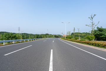 empty asphalt road with city skyline