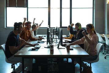 Group of people playing video games in internet cafe
