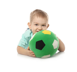 Cute little child with soft soccer ball on white background. Playing indoors