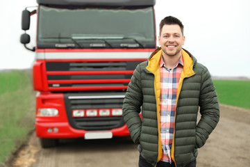 Portrait of driver at modern truck outdoors