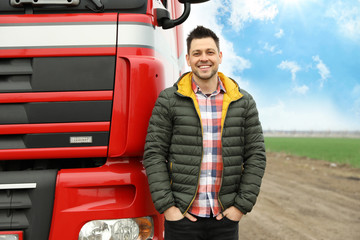Portrait of happy driver at modern truck outdoors. Space for text