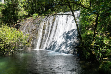 Fototapeta na wymiar Forest river waterfall on springtime