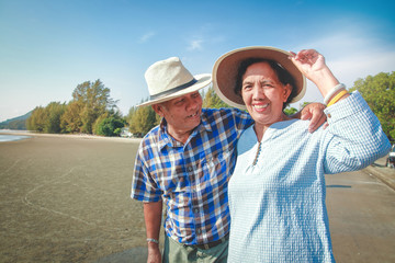 Happy two elderly couples come to the sea