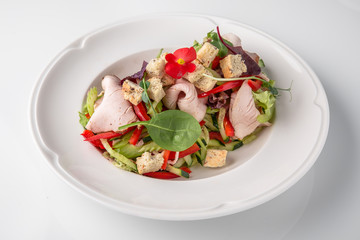 Salad of ham, prosciutto, pork or beef with vegetables, greens, berries and sauce. Nutritious, healthy dish. Banquet festive dishes. Gourmet restaurant menu. White background.