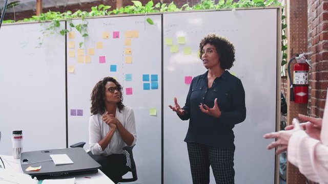 Female Creative Team Meeting To Discuss Ideas In Modern Office