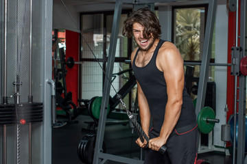 Fototapeta na wymiar Male athlete trains in the gym