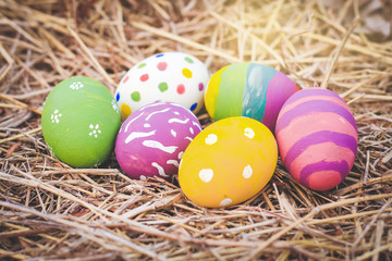 Many colorful Easter eggs, beautiful designs On the hay. Festival