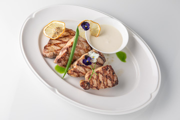 Grilled fish fillet: dorada, cod, halibut, pollock, tilapia. Seafood. Banquet festive dishes. Fine dining restaurant menu. White background.