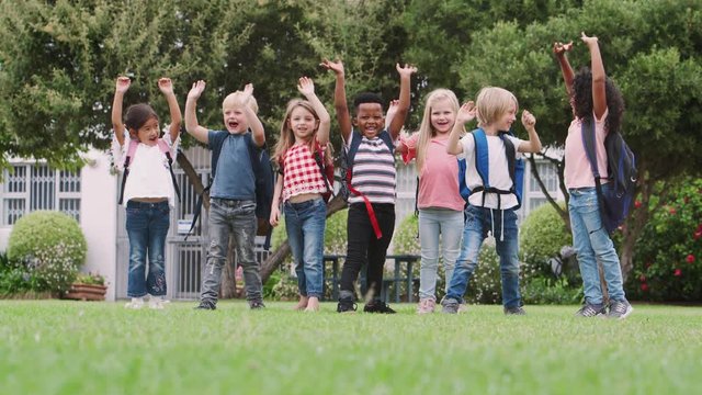 Portrait Of Excited Elementary School Pupils On Playing Field At Break Time