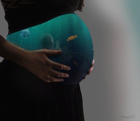 pregnant woman holding globe