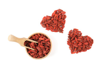 Composition with bowl, scoop and goji berries on white background, top view