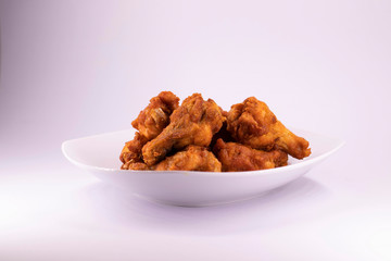 A white plate with fresh, crispy fried chicken