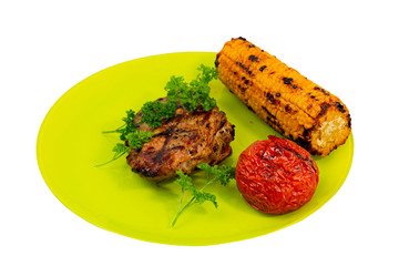 Close up view isolated of grilled steak, tomato and corn on green plate  on white background.  Food concept. Healthy food. Healthy lifestyle.