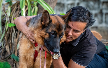 German Shepherd with Handler in Garden