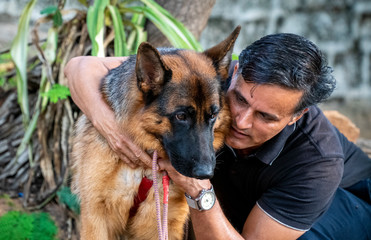 German Shepherd with Handler in Garden