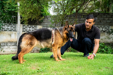 German Shepherd with Handler in Garden