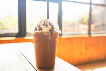Iced chocolate on wood table with blurred background