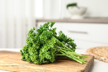 Board with fresh green parsley on table indoors