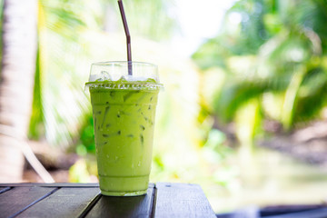 Iced matcha green tea mixed milk on wood table