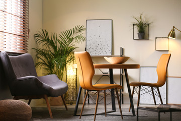 Stylish dining room interior with modern table set and window blinds