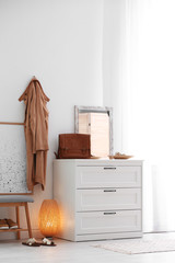 Modern hallway interior with shoe storage bench and chest of drawers. Space for text