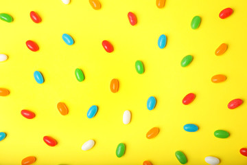 Flat lay composition with jelly beans on color background