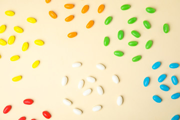 Flat lay composition with jelly beans on color background