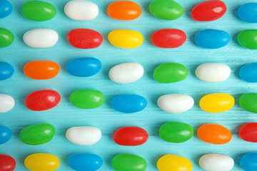 Flat lay composition with jelly beans on color background