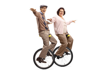 Senior man and woman riding unicycles and smiling © Ljupco Smokovski
