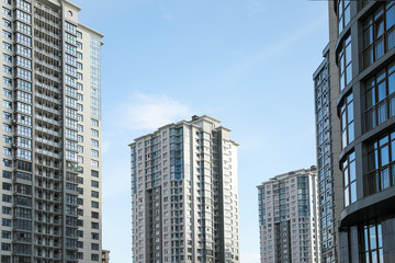 Fototapeta premium Nowoczesne budynki z przyciemnianymi szybami na tle nieba. Architektura miejska